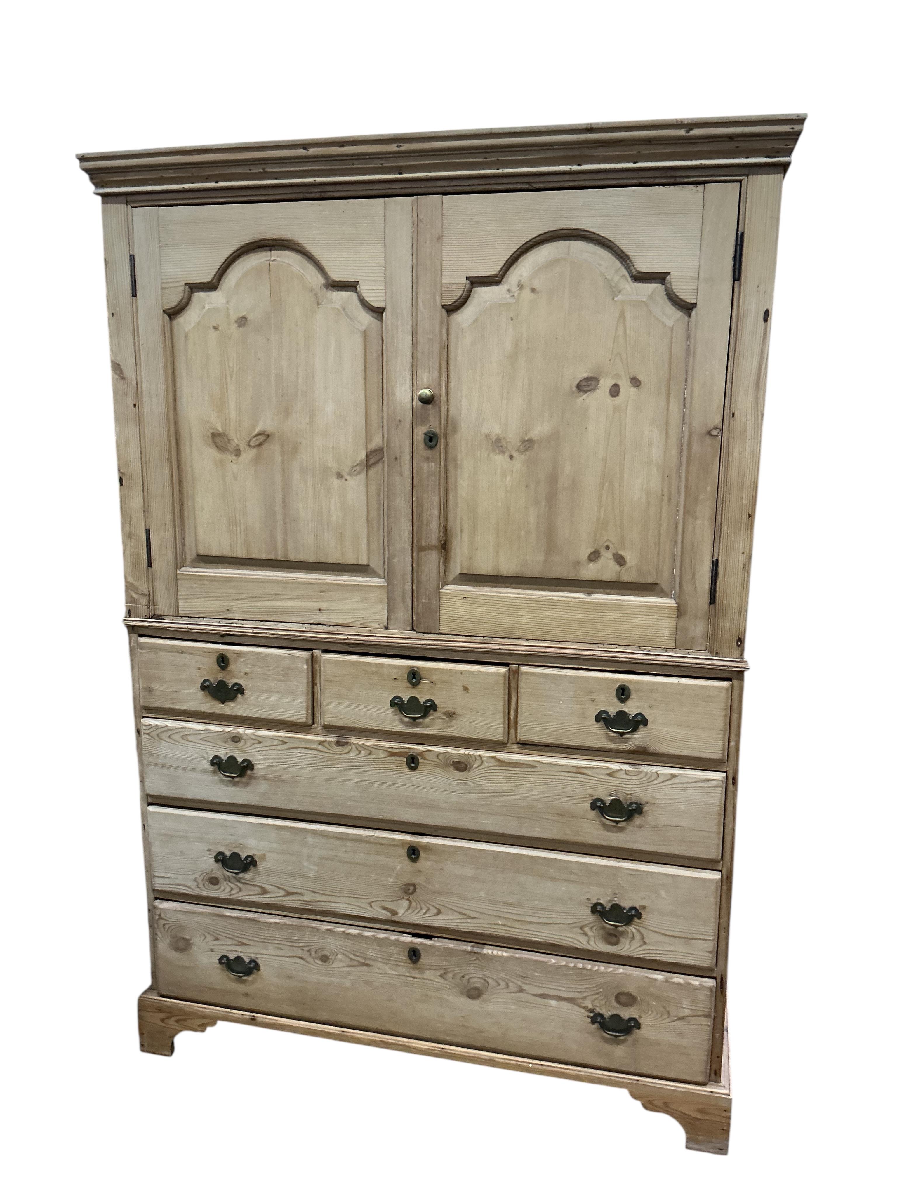 An early 19th century pine two part press cupboard, width 125cm, depth 54cm, height 191cm